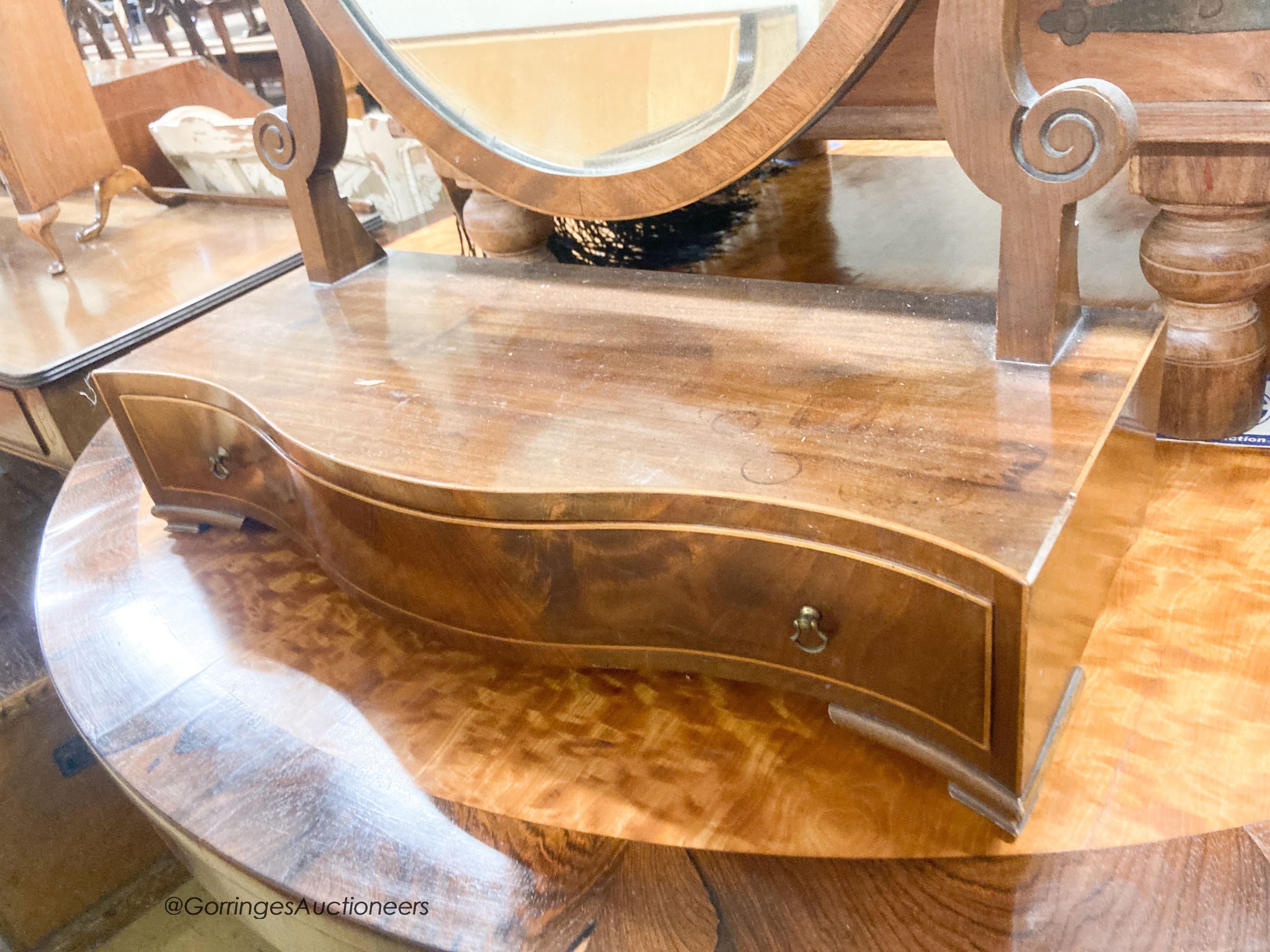 An Edwardian George III style mahogany serpentine toilet mirror, width 61cm, height 90cm